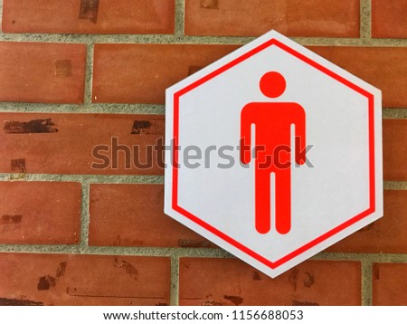 Men Toilet signs with old brick walls.