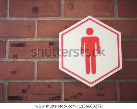 Men Toilet signs with old brick walls.