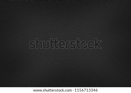 Charcoal black abstract texture and background with light center. Close up of textured surface