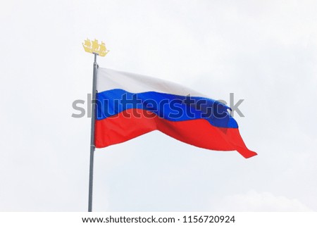 Russian Flag Isolated on Empty Sky Background. National Flag of Russia, Country Symbol View on Gloomy Weather. Russian Flag of White, Blue and Red Color on Mast Waving on Empty Sky Background.