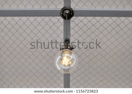 Photo of a hanging lamp/bulb that can be used for mock ups, design, art and patterns, background and textures.