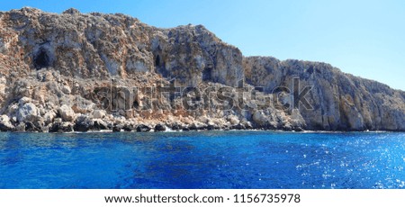 Panoramic view of rock landscape and blue wavy sea with sun glittering in Cyprus