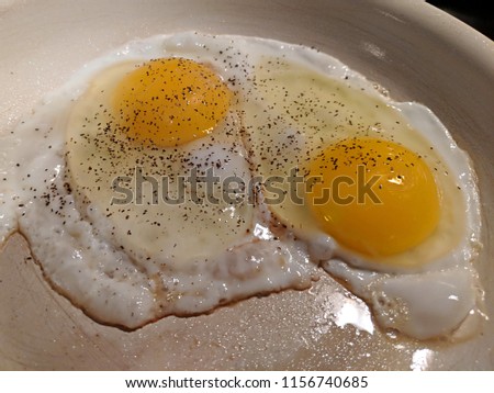 Fried eggs in copper non stick pan for breakfast with yellow yolks and cooking oil 2