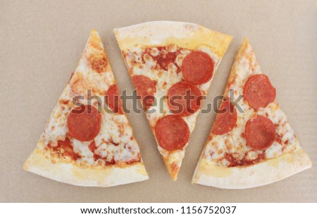 Pepperoni Pizza Slices Isolated on Empty Brown Craft Paper Background Top View. Simple Fast Food Banner with Pepperoni Sausage, Cheese and Tomato Sauce Pizza Slices Top View with Empty Copy Space