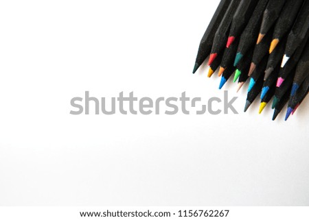 Black colour pencils on white background. Copy space