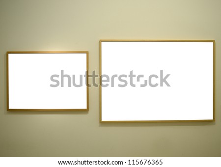Blank picture frames on gallery wall