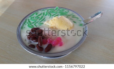 Durian Cendol is an iced sweet dessert that contains droplets of worm-like green rice flour jelly and coconut milk. Durian cendol means and fresh durian.