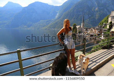 Young woman with dog pose for a photo in Hallstatt