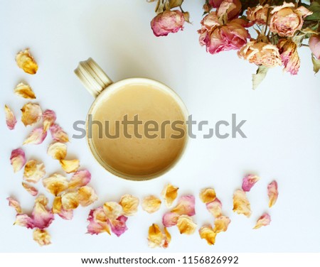 Picture of autumn background with dry roses and cup of coffee with copy space 