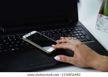 Close-up on the hands of a woman holding a mobile phone with a blank screen. Woman checks information, on the phone, shopping online. Technology development concept.