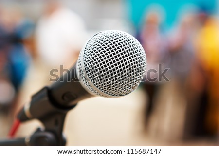 Professional microphone against people Royalty-Free Stock Photo #115687147