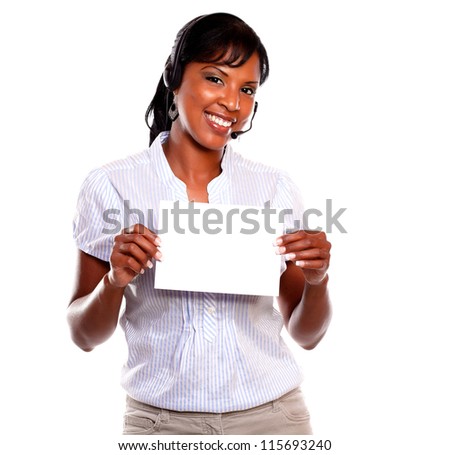 Adult female wearing headphones looking at you and holding white card on isolated background - copyspace