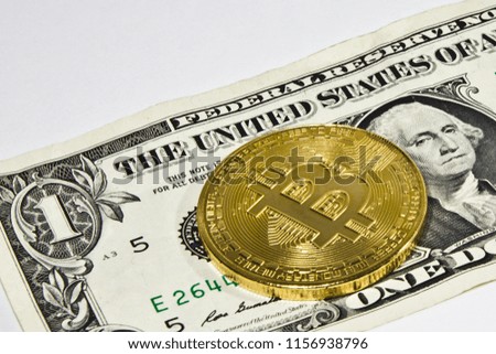 gold bitcoin on a one dollar bill