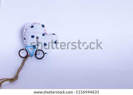 white heart and bicicle handmade on white background 