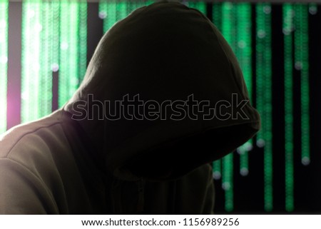 Hacker working with green screen