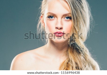 Beautiful girl with long blonde curly hair beauty portrait