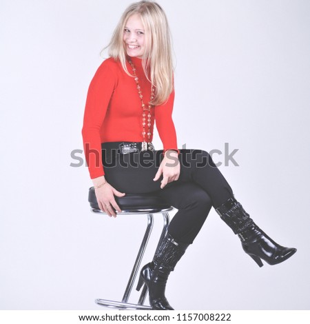 Blond lady in red sitting on high chair