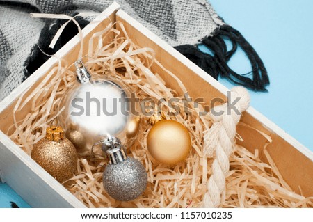 New Year's decorations in wooden box on blue background. Сopy space for text