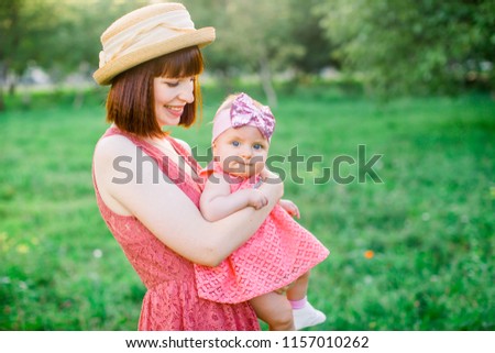Outdoor Portrait of happy family. family look. Happy mother having fun with her daughter