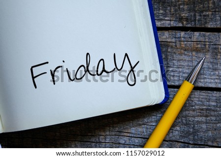 Friday inscription in notepad on table