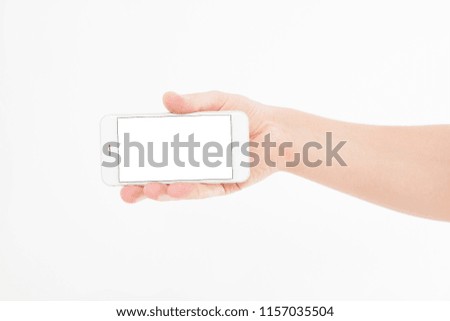 Hand holding white phone isolated on white clipping path inside. Top view.Mock up.Copy space.Template.Blank.