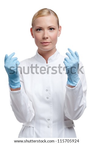 Medic puts on blue rubber gloves, isolated on white