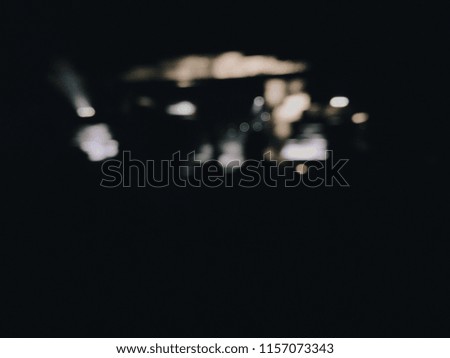 People dance at the music festival at night. Photo of crowd with raised up hands nightclub, audience applauding to musician band, night entertainment, music festival, happy youth. blurred photo