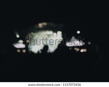People dance at the music festival at night. Photo of crowd with raised up hands nightclub, audience applauding to musician band, night entertainment, music festival, happy youth. blurred photo