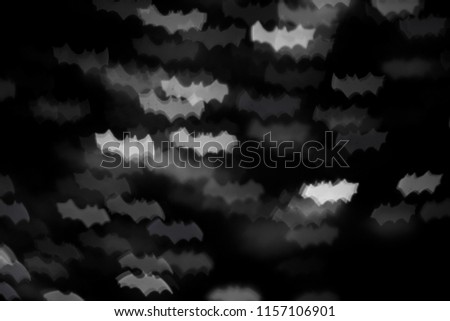 defocused white bats silhouette ghosts on black for halloween background - holidays, decoration and party concept