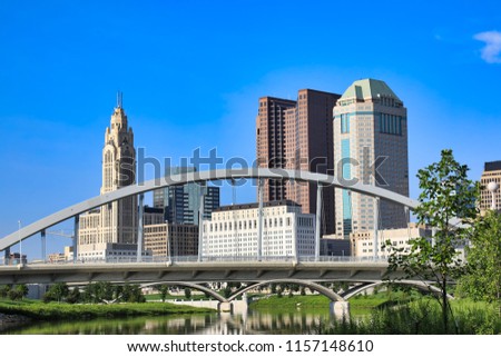 The Main Street Bridge is a major landmark in downtown Columbus, Ohio.  The Scioto Mile park adds green space to this skyline.