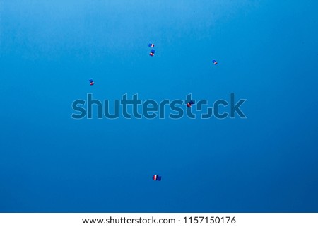 Parachutes on blue sky background.