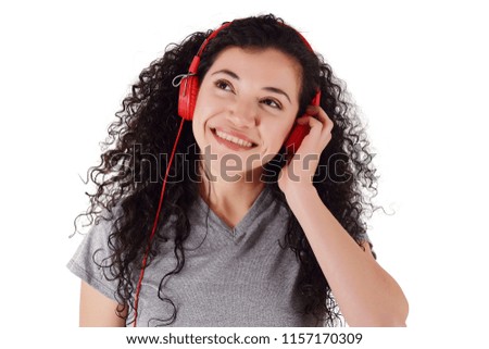 Young beautiful woman listening to music indoor. Isolated white background.