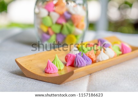 Close up thai candy (allure) on wooden dish for served in party. Delicious dessert for gift to someone you love. Make from coconut milk, sugar, flour.