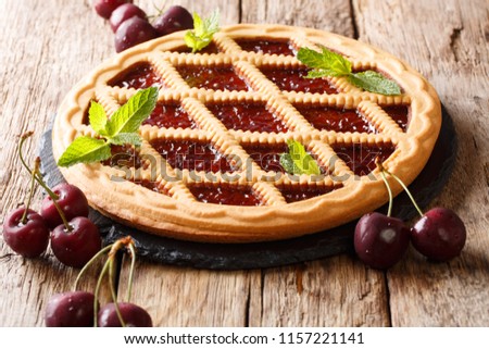Delicious traditional berry cherry pie Crostata close-up on the table. horizontal, rustic 
