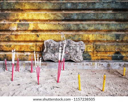 candles with incenses in an incense pot,to pay respect to the Buddha