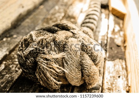 Pile of old weathered nautical ropes on dock, close up in Key West harbor, Florida, USA.
