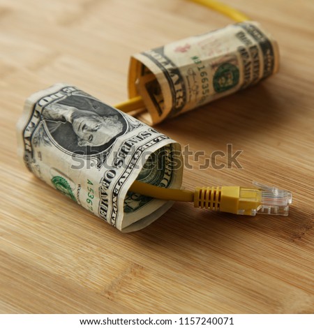The cost of internet data plans in America concept image consisting of USA dollar bills and an Ethernet cable.  This image can also be used to represent net neutrality or online income. 