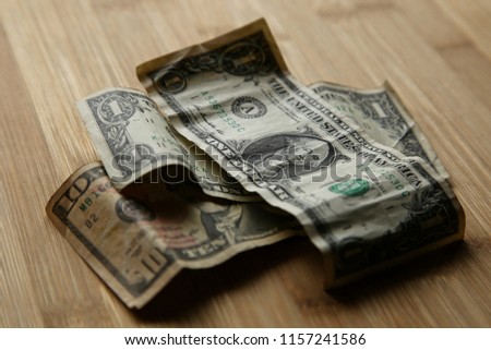 USA dollar notes on a wooden background.  This image can be used to represent payment or money.