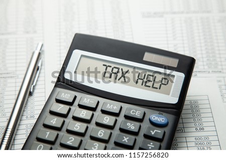 Tax help. On display of calculator is written tax help Royalty-Free Stock Photo #1157256820