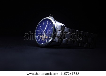 Stainless steel style statement watch on a dark background