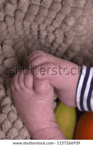 Closeup newborn baby feet on a blanket