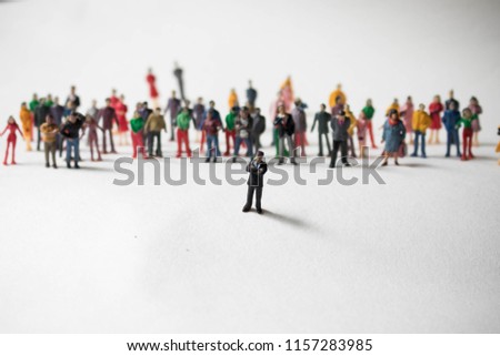 Man in front of a large crowd of followers. Leadership role in business or social media. Person with many followers standing ahead of the crowd. Innovator or influencer is a mentor to a huge crowd.