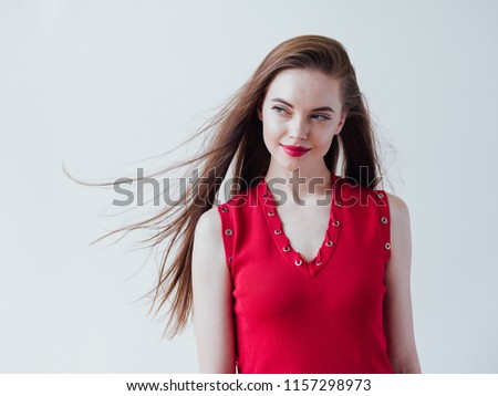 Red lips woman with long brunette hair and red dress female happy young beautiful portrait