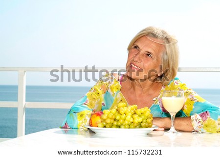 Beautiful adult woman on the balcony of her hotel