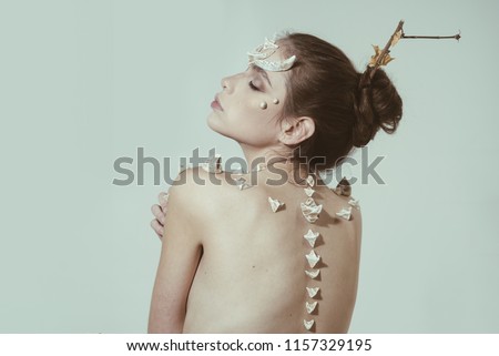 Woman with thorns on back shoulders looks like fantasy creature. Halloween ideas concept. Scary fairy tail character. Girl with thorns devil dragon magical creature. Girl with fantasy style make up.