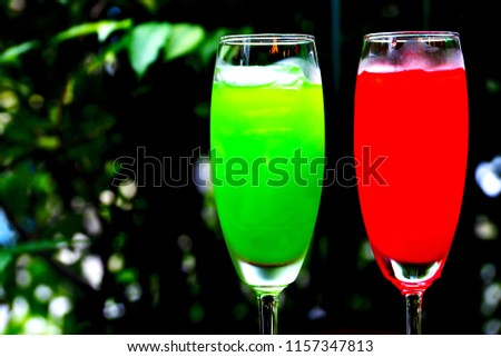 Refreshing fruit punch beverage in glass on wooden background          