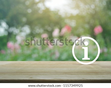 Information sign icon on wooden table over blur pink flower and tree in garden, Business and industry customer support concept
