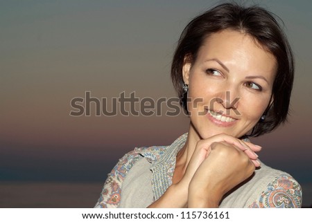 Cheerful young woman relaxing on nature