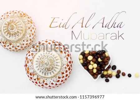 Eid Al Adha sacrifice festival, Islamic Arabic candle and sweet chocolate sugar. Eid al adha mubarak means happy festival of sacrifices