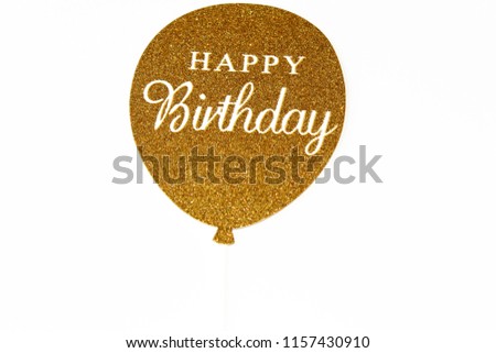 golden birthday balloon with glitter, on the globe is written happy birthday white background